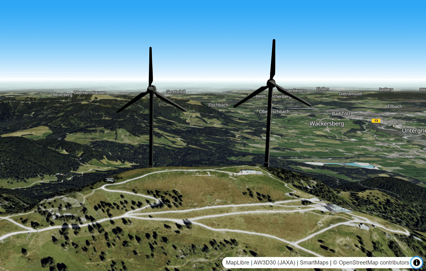Auf einer digitalen Geländekarte sind die dreidimensionalen Modelle zweier Windturbinen dargestellt.